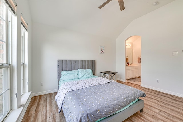 12165 Shoal Creek Dr, Frisco, TX 75035 - bedroom with arched walkways, vaulted ceiling, wood finished floors, baseboards, and ensuite bath