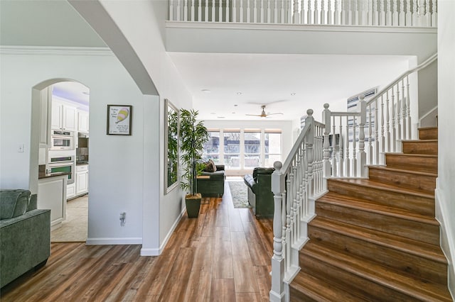 12165 Shoal Creek Dr, Frisco, TX 75035 - entryway with ceiling fan, stairway, wood finished floors, baseboards, and crown molding