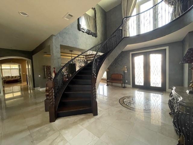 1900 Durance Ct, Corinth, TX 76210 - foyer featuring visible vents, arched walkways, stairs, and a towering ceiling