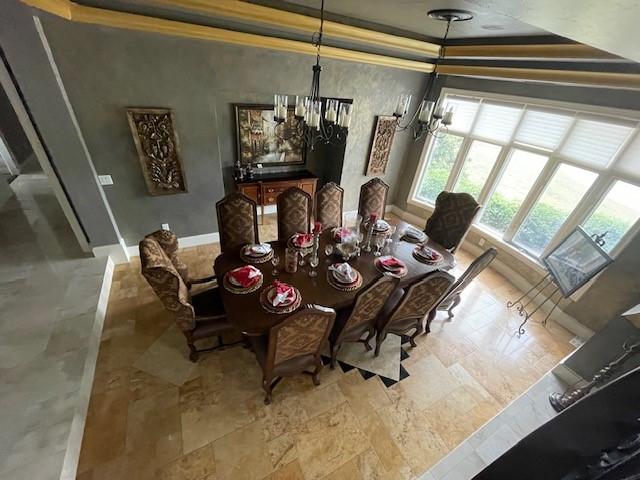 1900 Durance Ct, Corinth, TX 76210 - dining room featuring crown molding, stone finish flooring, a chandelier, a tray ceiling, and baseboards