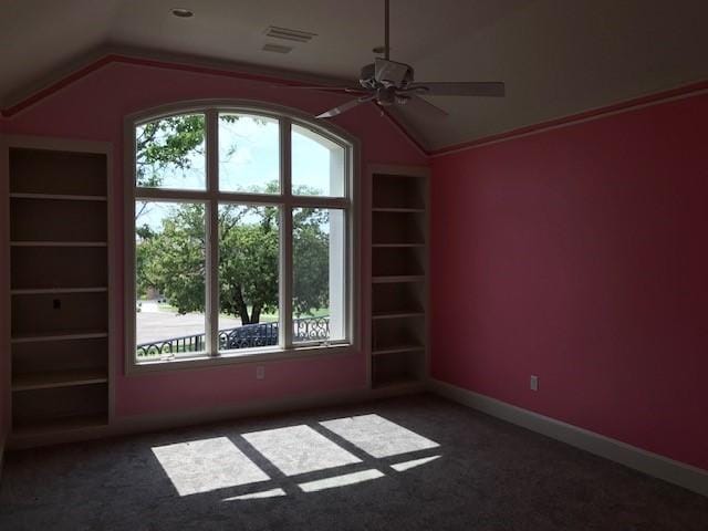 1900 Durance Ct, Corinth, TX 76210 - carpeted empty room featuring visible vents, ceiling fan, built in features, and vaulted ceiling