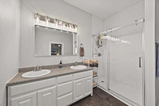 bathroom with double vanity, a sink, and a shower stall