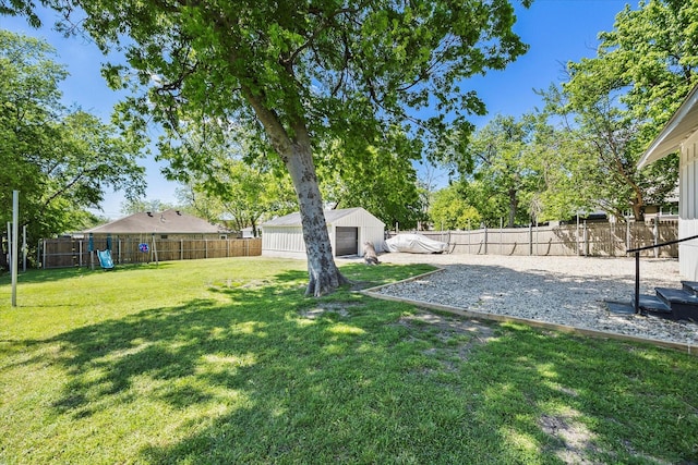 view of yard with a fenced backyard and a playground