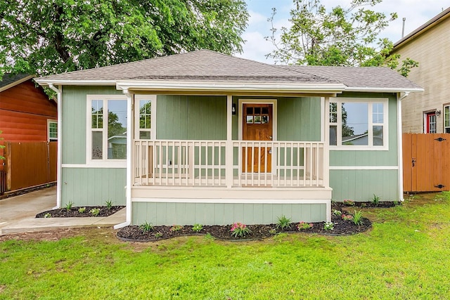 5105 Birchman Ave, Fort Worth, TX 76107 - view of front of house with a front lawn, fence, covered porch, and roof with shingles