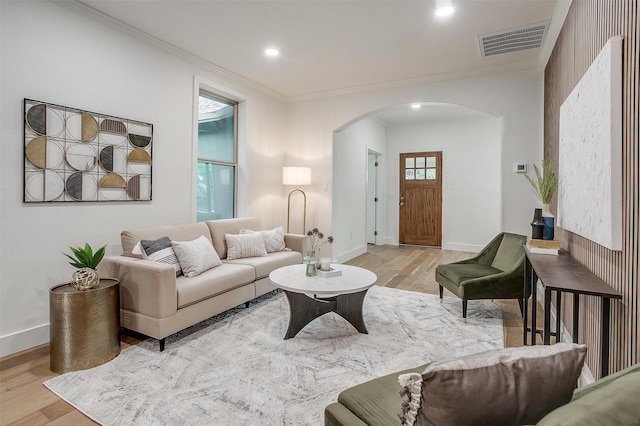 5105 Birchman Ave, Fort Worth, TX 76107 - living area featuring visible vents, light wood-type flooring, crown molding, and arched walkways