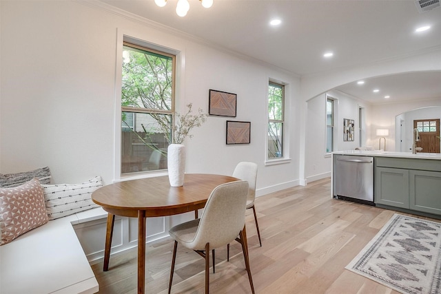 5105 Birchman Ave, Fort Worth, TX 76107 - dining area with visible vents, light wood-type flooring, arched walkways, and ornamental molding