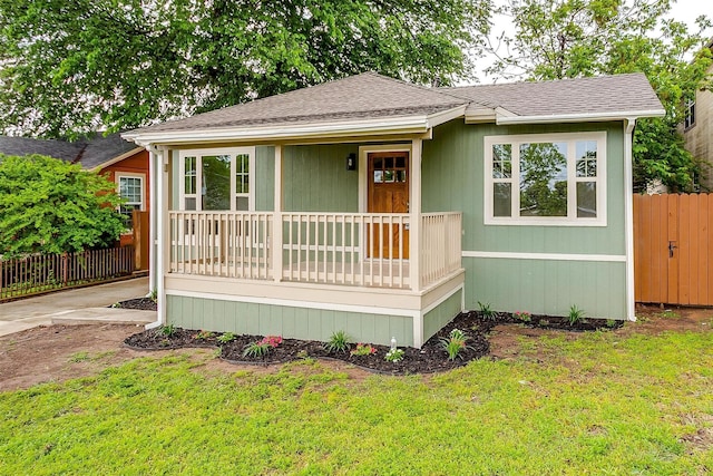 5105 Birchman Ave, Fort Worth, TX 76107 - view of front facade with a porch, a front yard, roof with shingles, and fence