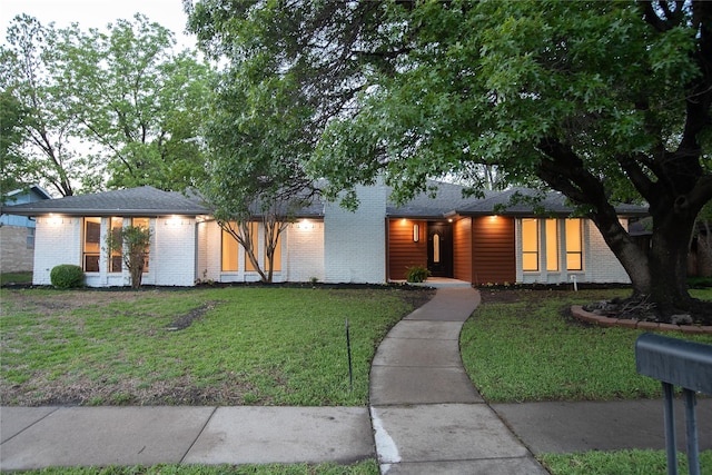 2509 Skiles Dr, Plano, TX 75075 - view of front facade with brick siding and a front lawn