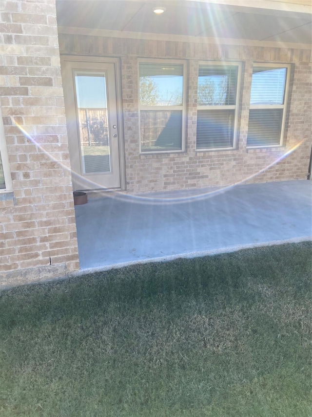 view of exterior entry with brick siding