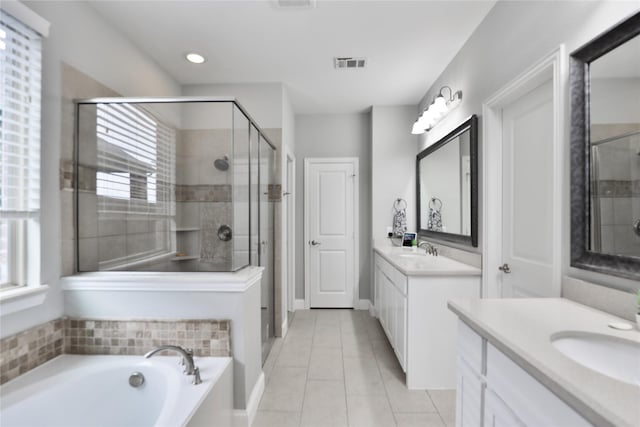 bathroom with visible vents, a stall shower, and a sink