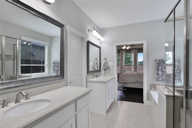 bathroom with tile patterned floors, two vanities, ceiling fan, and a sink