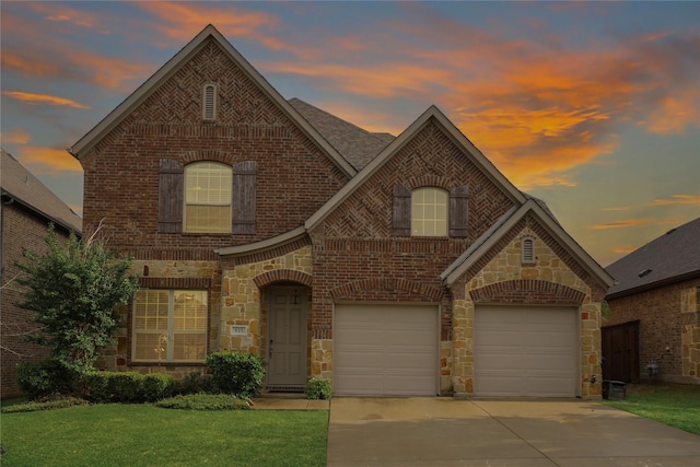 traditional-style house with a garage, driveway, stone siding, and brick siding