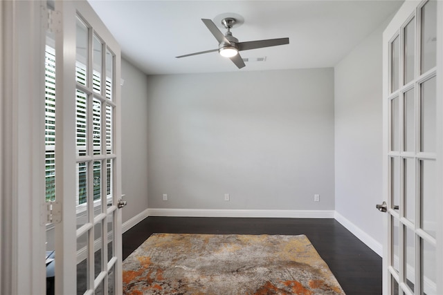 925 Spring Falls Dr, Mckinney, TX 75071 - spare room featuring french doors, dark wood-type flooring, a ceiling fan, and baseboards