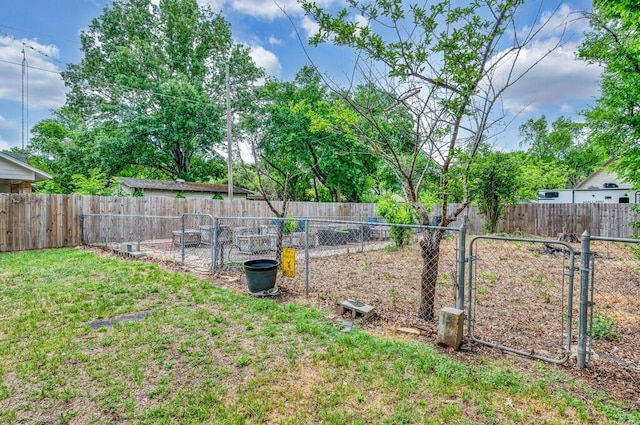 view of yard featuring a gate and a fenced backyard