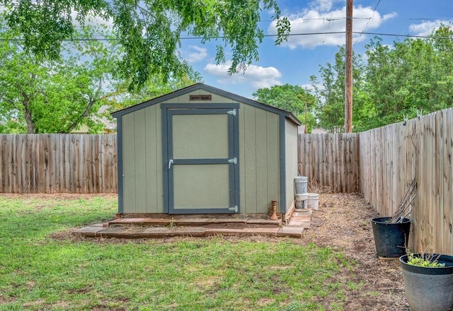 view of shed with a fenced backyard