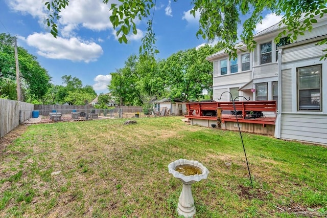 view of yard with a deck and a fenced backyard