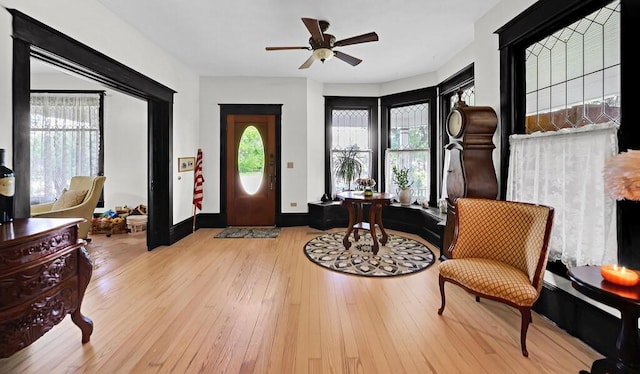 entryway with a ceiling fan, baseboards, hardwood / wood-style flooring, and a healthy amount of sunlight