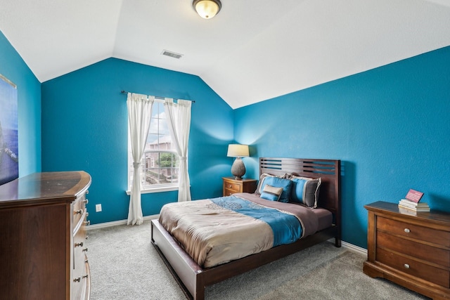 bedroom featuring visible vents, baseboards, vaulted ceiling, and carpet floors
