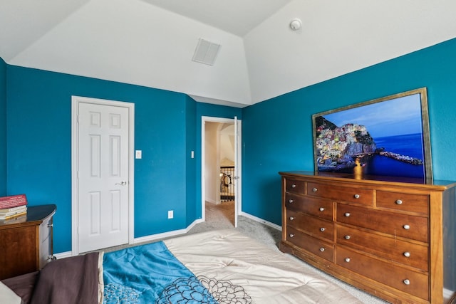 carpeted bedroom featuring baseboards, visible vents, and lofted ceiling