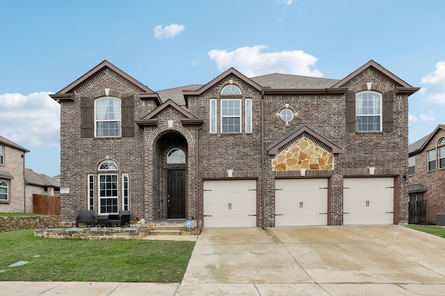 traditional-style home with a garage, brick siding, a front lawn, and concrete driveway