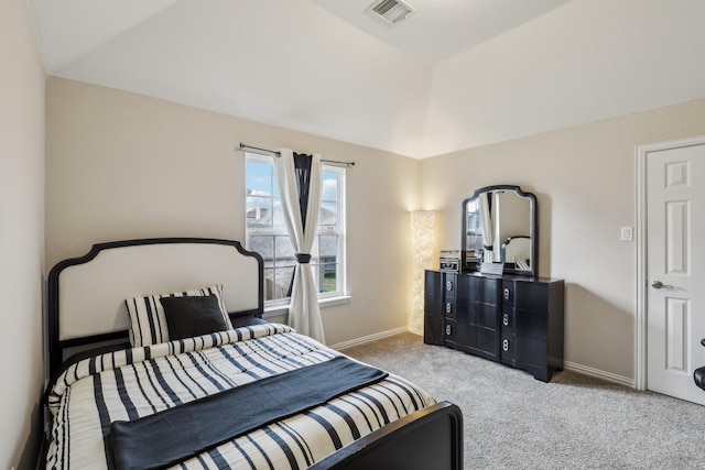 carpeted bedroom featuring baseboards, visible vents, and vaulted ceiling