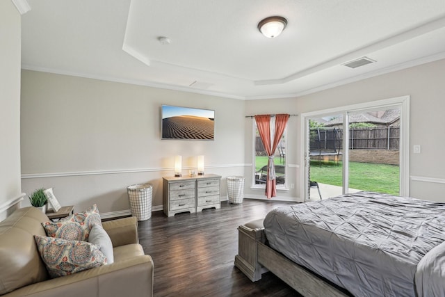 bedroom with crown molding, a raised ceiling, visible vents, access to exterior, and dark wood finished floors