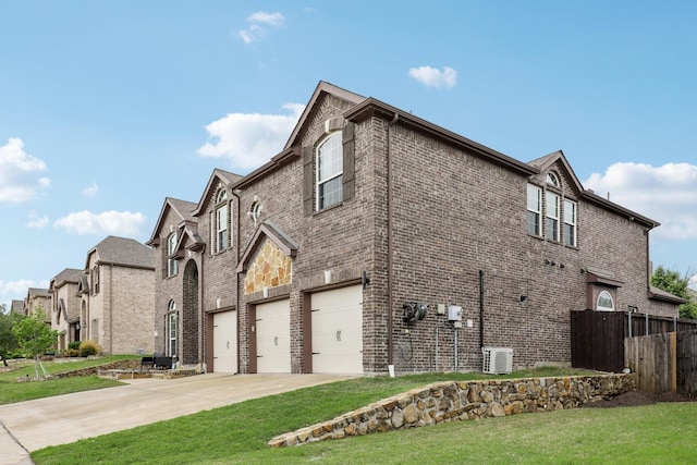 view of home's exterior with a garage, a lawn, driveway, brick siding, and fence