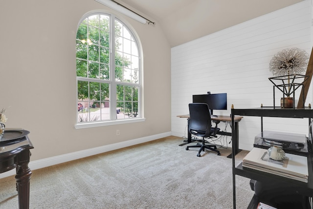 office area with carpet floors, baseboards, vaulted ceiling, and a healthy amount of sunlight