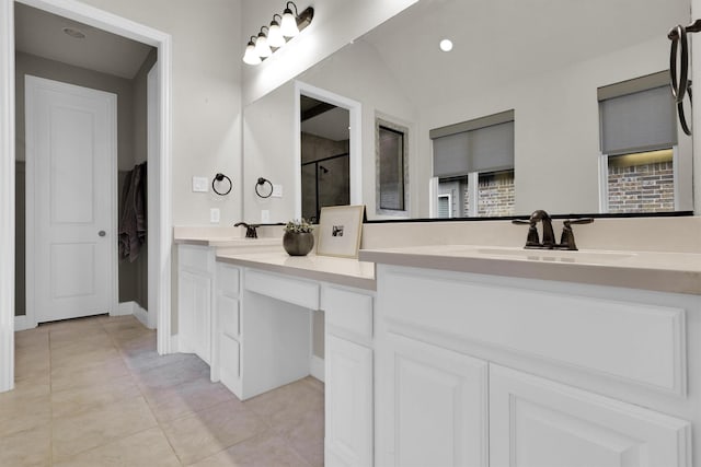 bathroom with a sink, tile patterned flooring, a shower stall, and double vanity