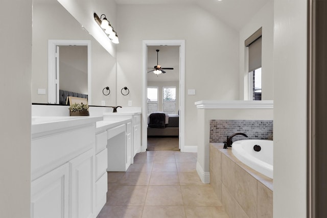 bathroom featuring double vanity, ceiling fan, a bath, connected bathroom, and lofted ceiling