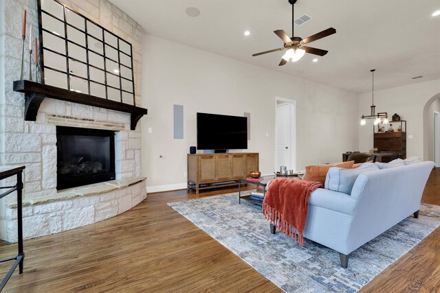 dining room with recessed lighting, baseboards, a glass covered fireplace, and ceiling fan with notable chandelier