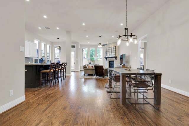 interior space with baseboards, a chandelier, french doors, and wood finished floors