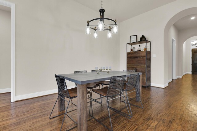 living area featuring visible vents, wood finished floors, a fireplace, arched walkways, and a ceiling fan