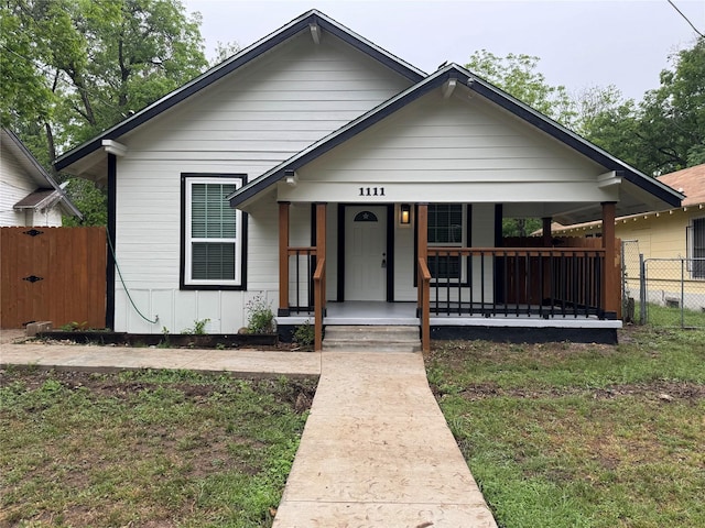 bungalow-style home with fence and a porch