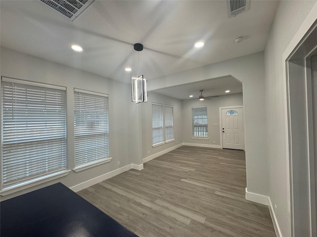 unfurnished dining area with a ceiling fan, visible vents, and baseboards