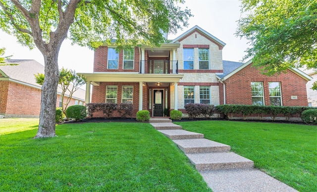 7955 Rasor Dr, Frisco, TX 75036 - view of front of home featuring a balcony, brick siding, and a front yard