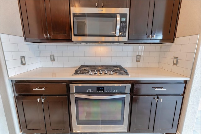 7955 Rasor Dr, Frisco, TX 75036 - kitchen with stainless steel appliances, light countertops, dark brown cabinetry, and decorative backsplash