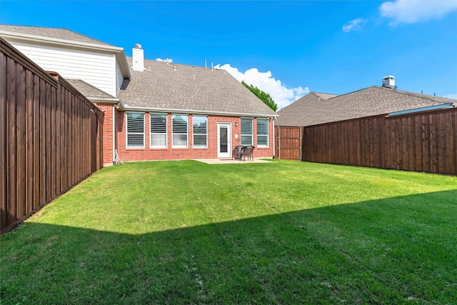 7955 Rasor Dr, Frisco, TX 75036 - rear view of house featuring brick siding, a chimney, and roof with shingles