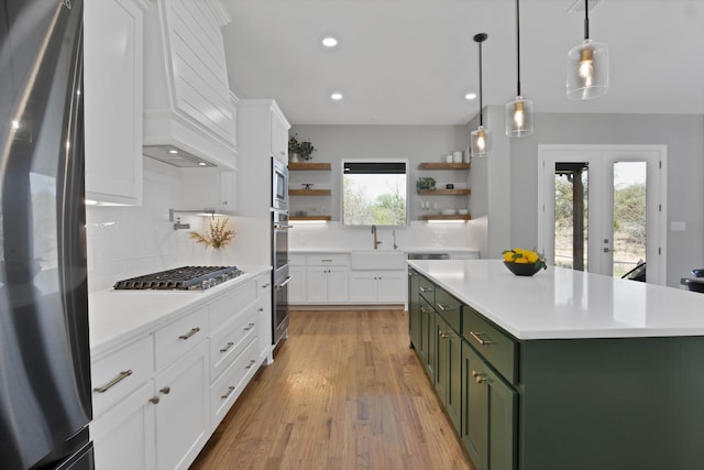 108 Grace View Rd, Weatherford, TX 76088 - kitchen featuring open shelves, appliances with stainless steel finishes, green cabinets, light countertops, and custom exhaust hood