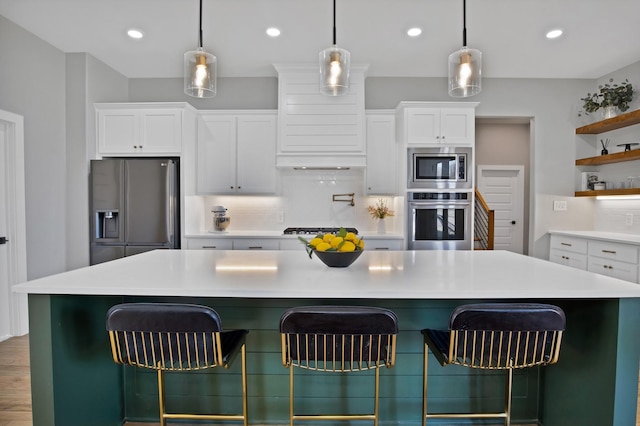 108 Grace View Rd, Weatherford, TX 76088 - kitchen featuring decorative backsplash, a kitchen breakfast bar, open shelves, white cabinetry, and appliances with stainless steel finishes