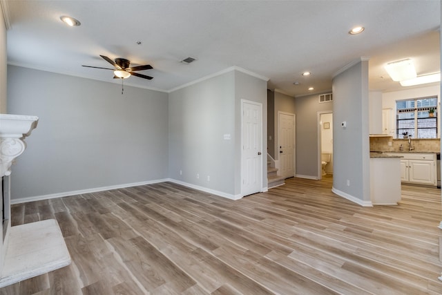 unfurnished living room with visible vents, ceiling fan, baseboards, recessed lighting, and ornamental molding