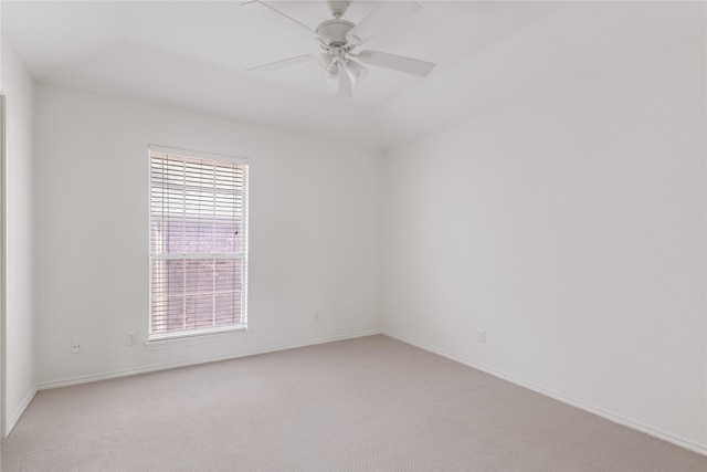 unfurnished room featuring a healthy amount of sunlight, ceiling fan, and light carpet