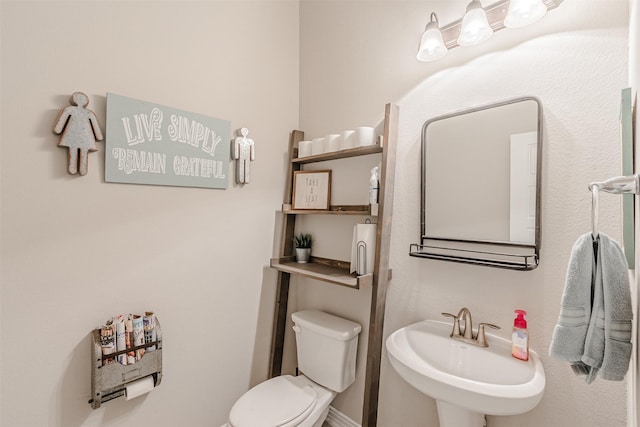 14733 Cedar Flat Way, Fort Worth, TX 76262 - half bathroom featuring baseboards, toilet, and a sink