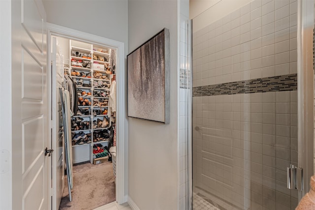 14733 Cedar Flat Way, Fort Worth, TX 76262 - bathroom featuring baseboards, a shower stall, and a spacious closet