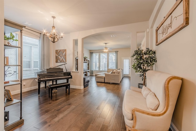 14733 Cedar Flat Way, Fort Worth, TX 76262 - living area with visible vents, baseboards, arched walkways, dark wood-style flooring, and ceiling fan with notable chandelier