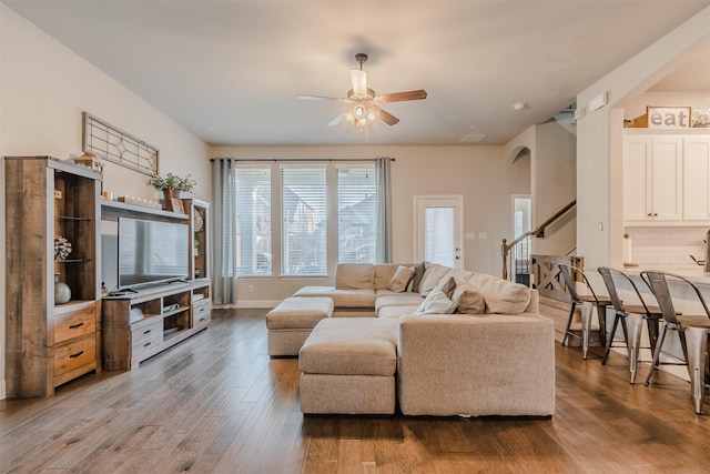 14733 Cedar Flat Way, Fort Worth, TX 76262 - living room featuring wood finished floors, arched walkways, stairs, baseboards, and a ceiling fan