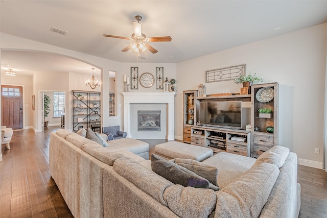 14733 Cedar Flat Way, Fort Worth, TX 76262 - living room with wood finished floors, arched walkways, ceiling fan with notable chandelier, baseboards, and visible vents