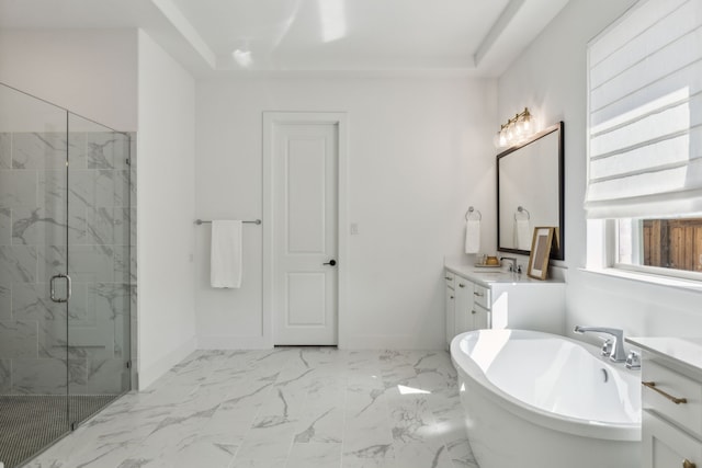 bathroom with a marble finish shower, vanity, marble finish floor, a freestanding bath, and baseboards