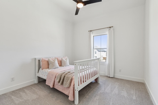 carpeted bedroom featuring ceiling fan and baseboards