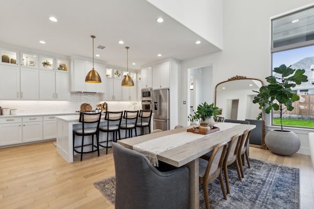 dining space featuring recessed lighting, light wood-type flooring, and visible vents